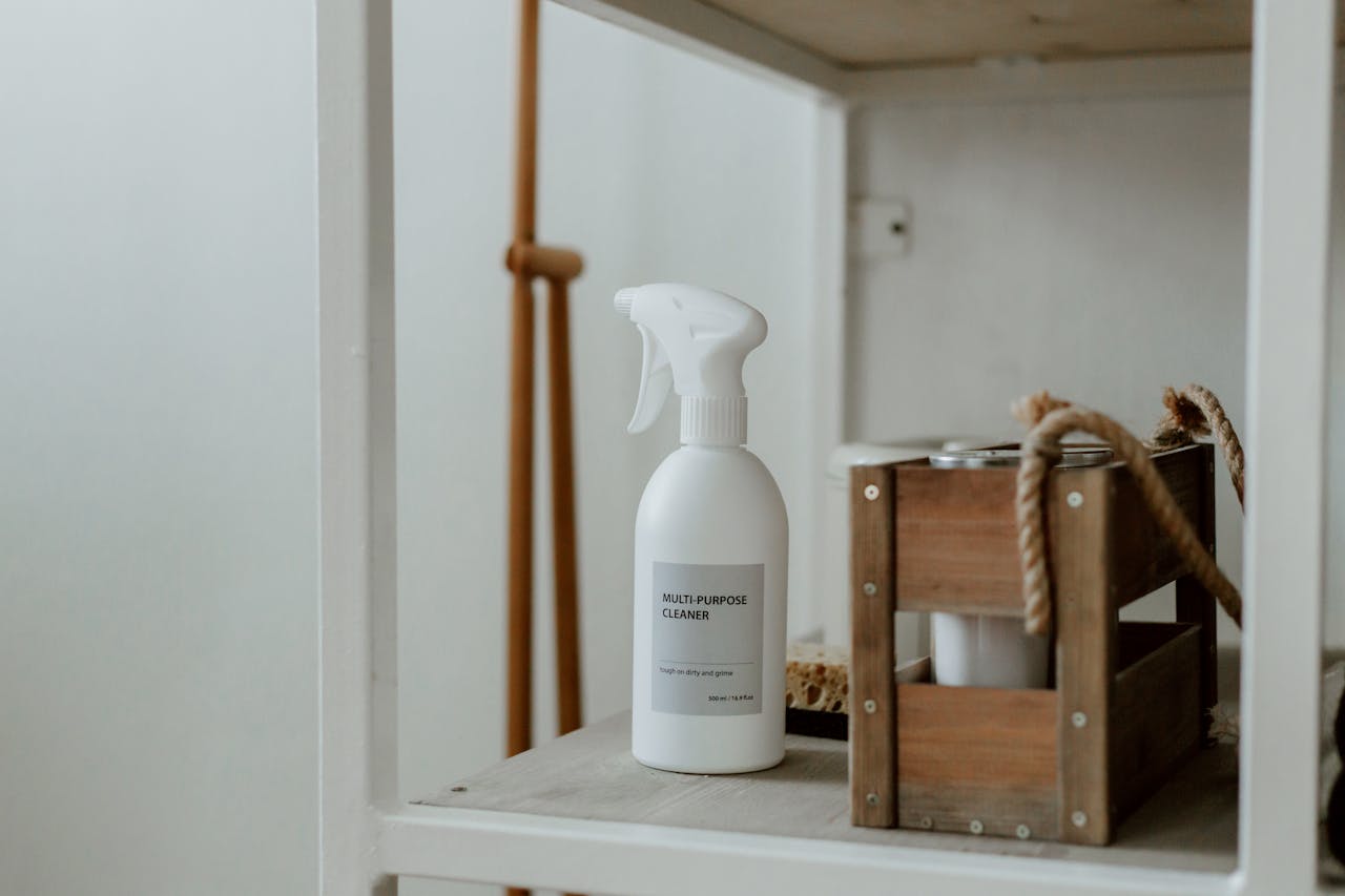 services-03 Clean white shelf with a spray cleaner and wooden caddy, perfect for home organization.